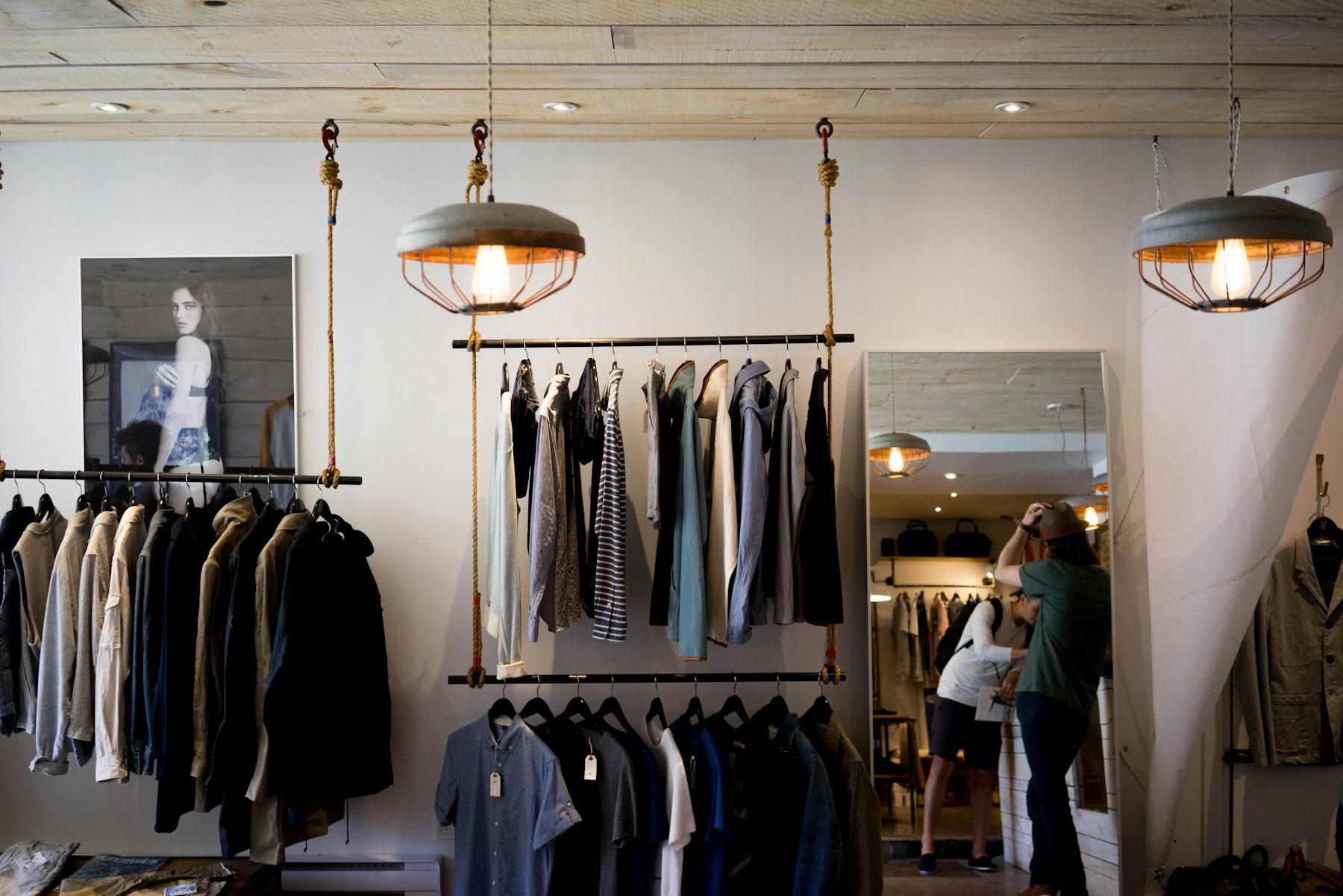A boutique with hanging rails and pendant lamps